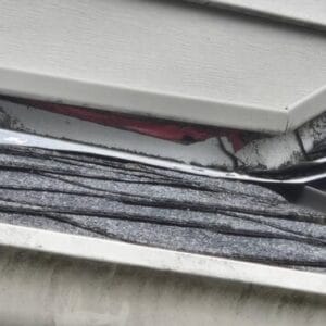 The wall flashing was installed very poorly, and is not flush to the valley metal. 